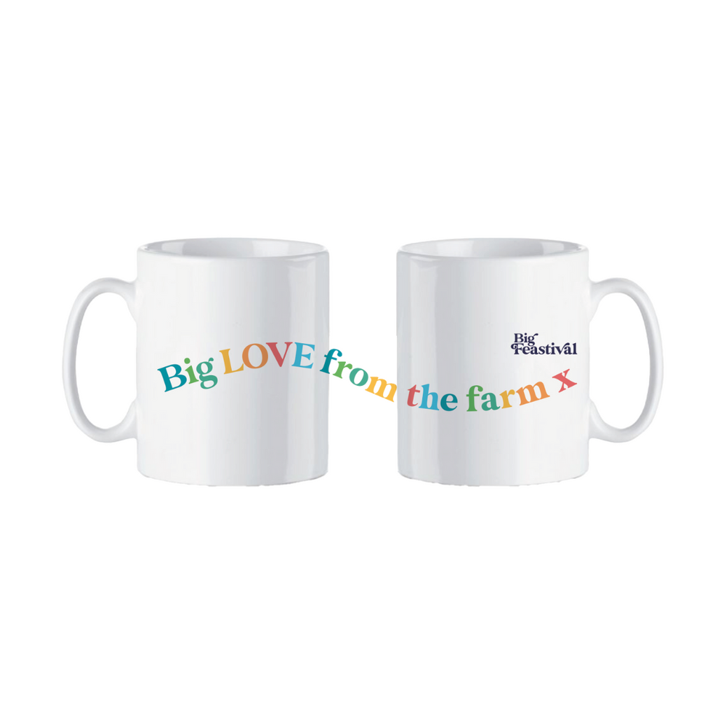 Two white ceramic Big Feastival mugs, featuring vibrant text reading Big LOVE from the farm x and The Big Feastival logo, are shown together to showcase both cheerful designs.