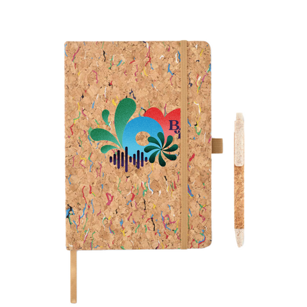 The 2025 Notebook features a cork cover with a colorful abstract logo, tan elastic band, ribbon bookmark, and matching cork pen in a side loop. The background showcases a multicolored speckled pattern.