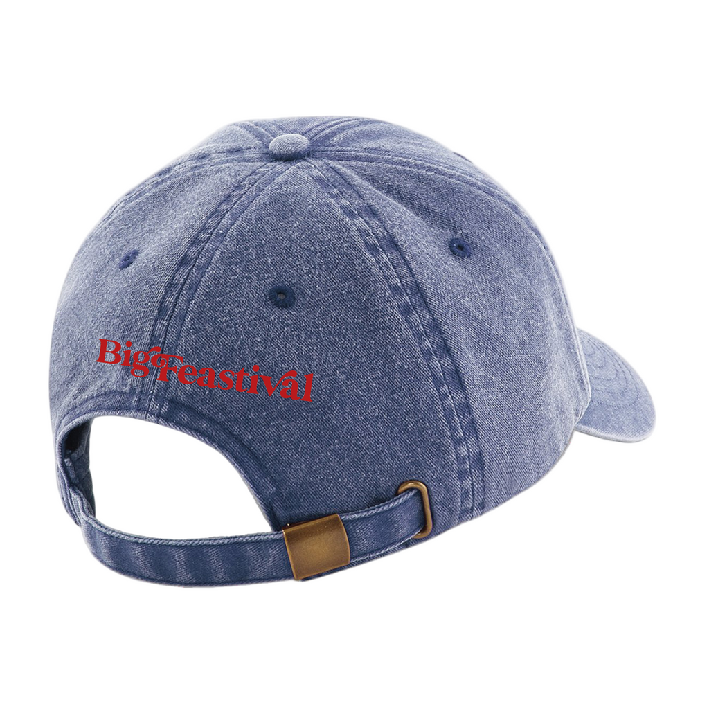 The 2025 Baseball Cap is a blue denim hat viewed from the back, showing an adjustable strap with a brass buckle and Bigcreastival embroidered in red above the opening.