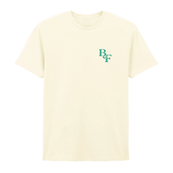 The Big Feastival 2025 Line Up T-Shirt Off White by 2025 features small green overlapping BDF letters on the left chest, shown on a white background.