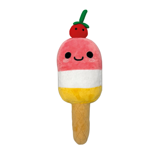 The Ice Lolly Plush by 2025 is a popsicle-shaped toy with a smiling face, pink top, white and yellow middle, tan cone bottom, plus a red cherry and green stem on top.